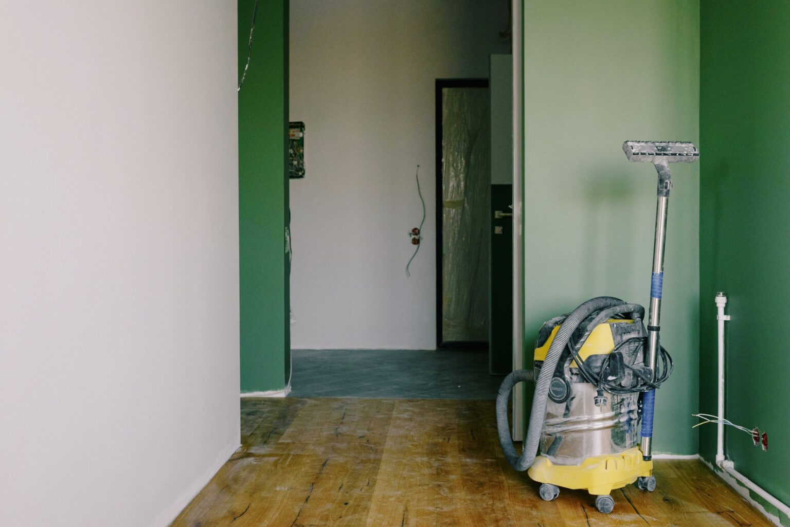 Room with new walls and wood flooring during the rebuild after water damage