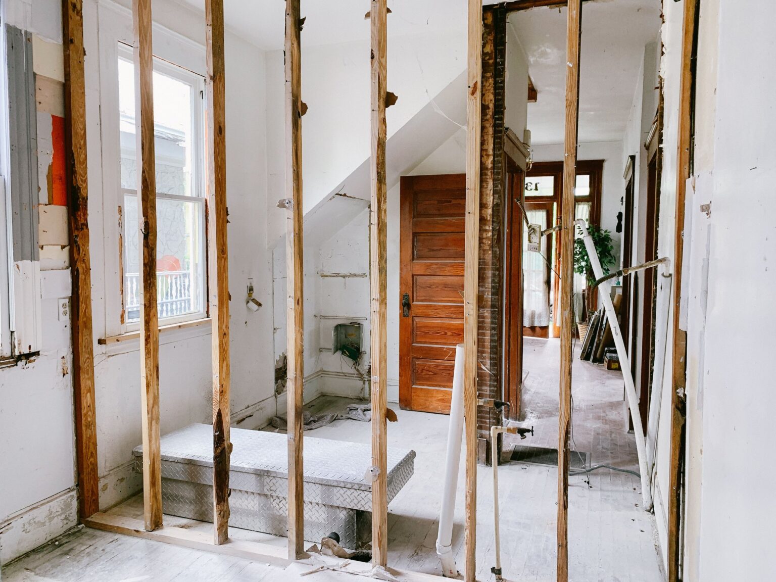 Water-damaged walls opened down to the studs so the framing can dry