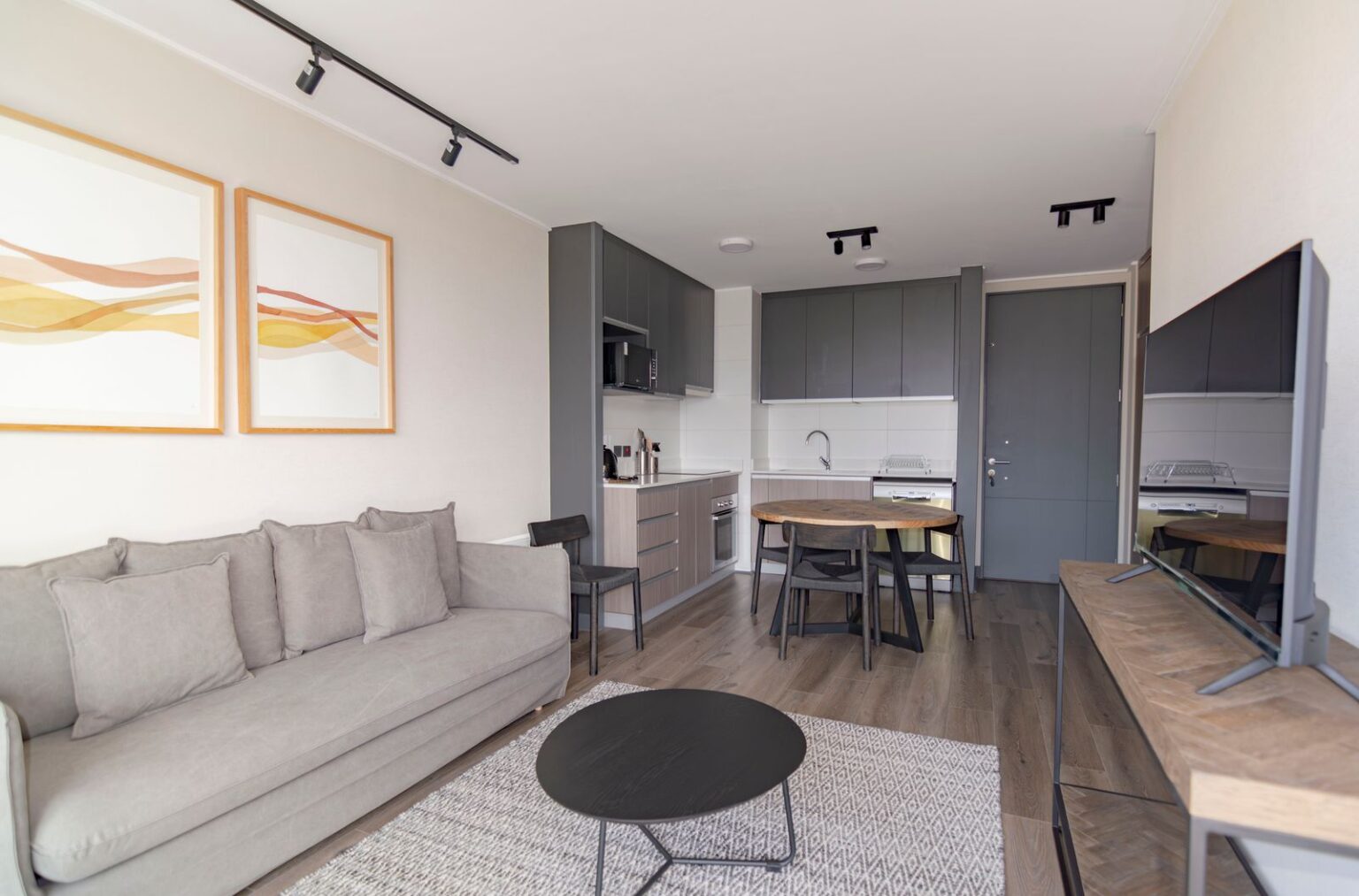 Compact living room with a kitchenette, an example of an ADU interior (stock photo)