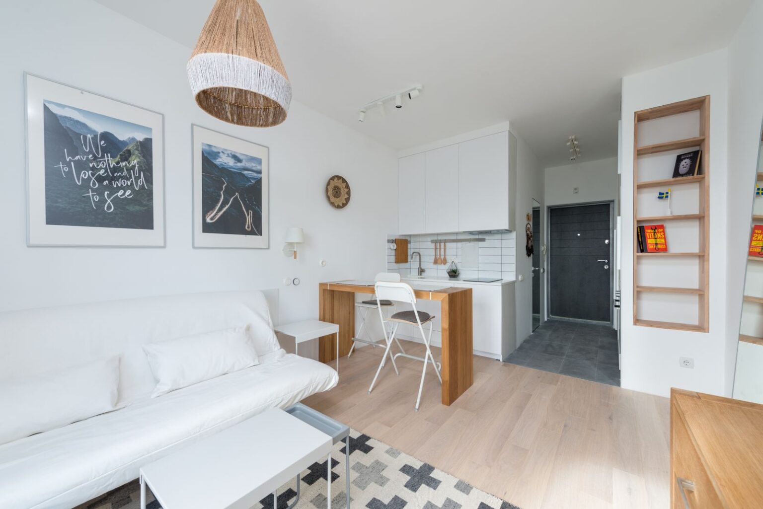 Bright studio living space with a small kitchen, an example of an ADU layout (stock photo)