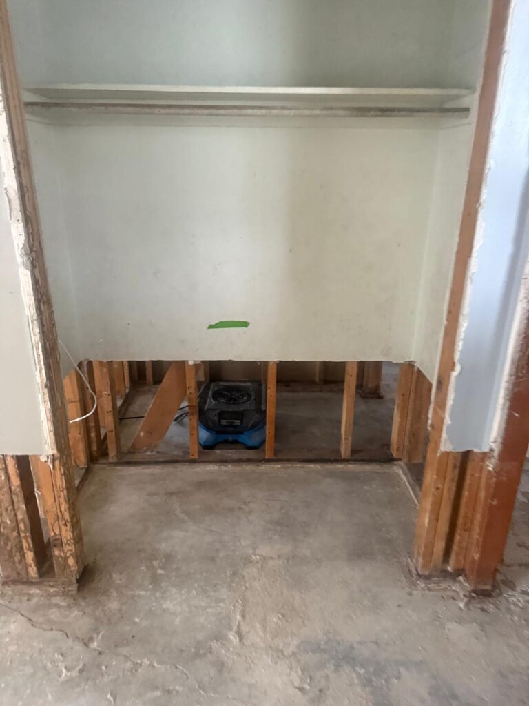 Closet wall cut open so air can reach the framing behind it